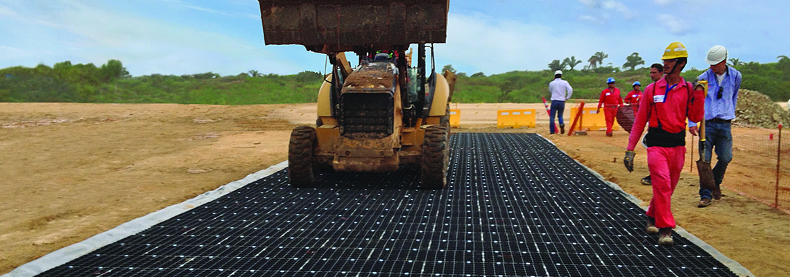 construction workers laying GEOTERRA mats