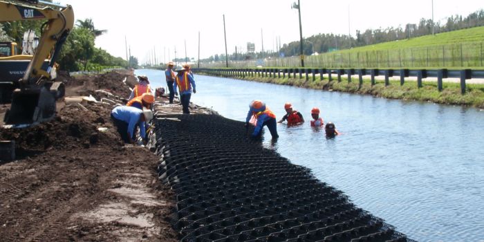 workers installing geocells on streambank