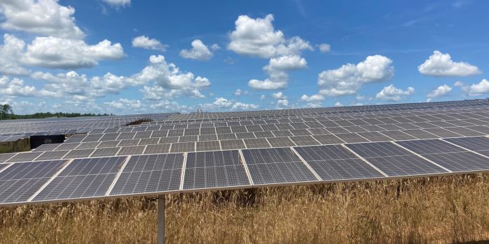 photo of solar panels on solar farm with blue sky and clouds background